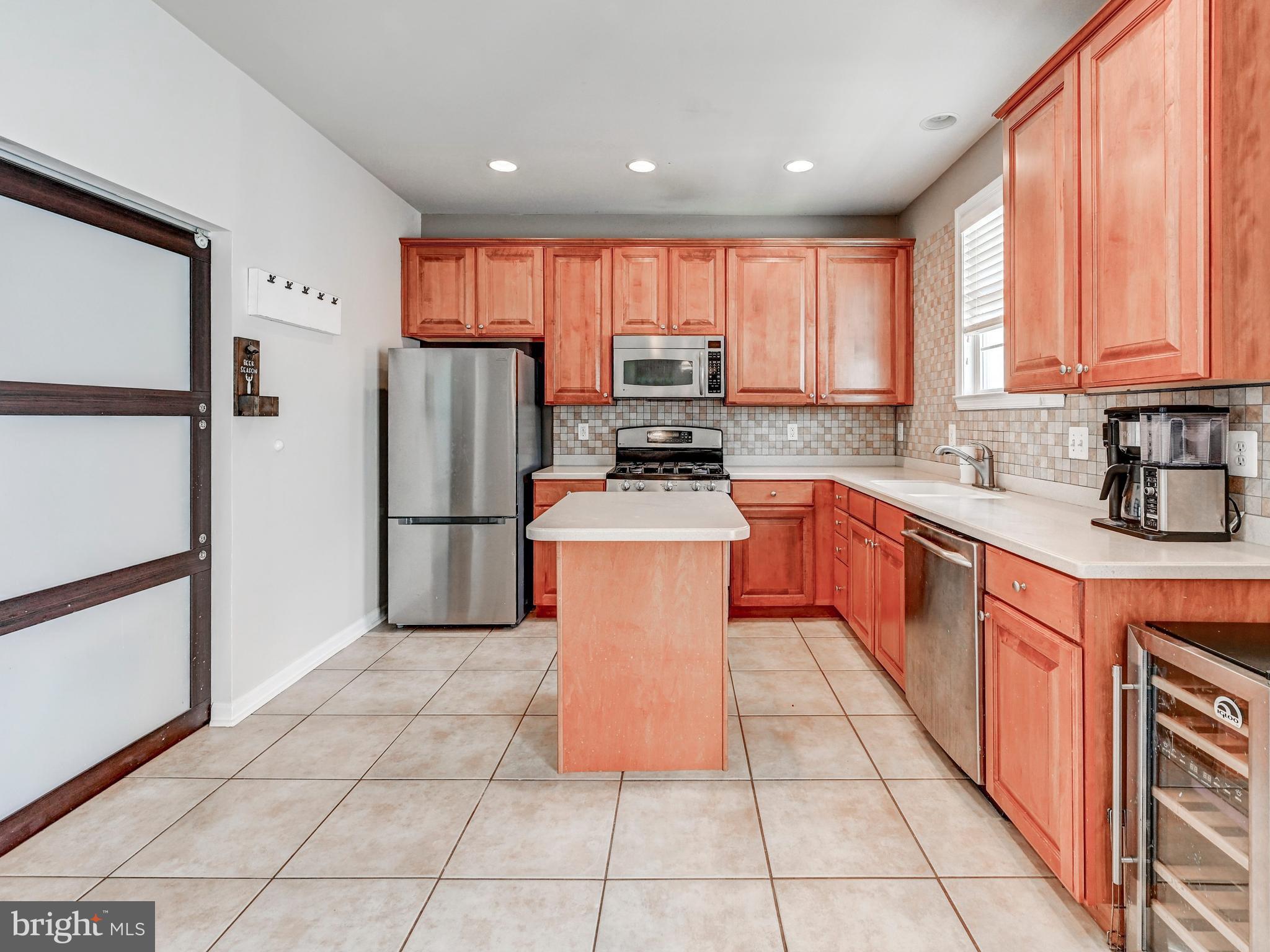 254 North Front Street New Freedom, PA 17349 - Photo 6 of 23 a kitchen with stainless steel appliances granite countertop a stove top oven a sink a counter top space cabinets and a window