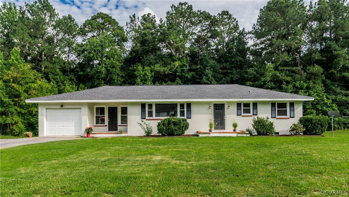 a front view of house with yard and green space