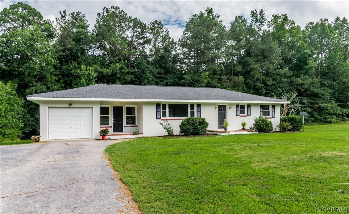 11407 Reedy Branch Road South Chesterfield, VA 23838 - Photo 4 of 50 a front view of a house with a garden and trees