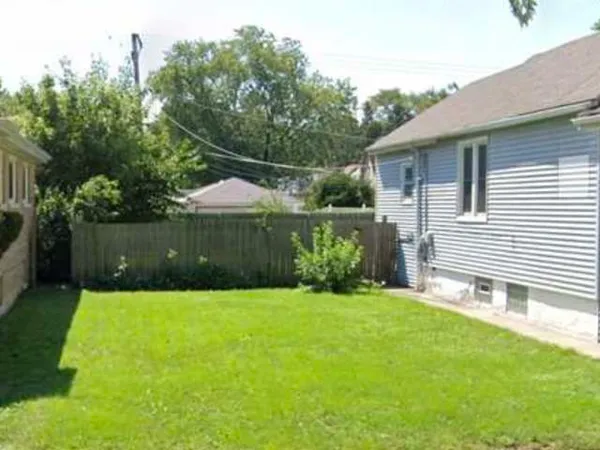 a backyard of a house with a garden and plants