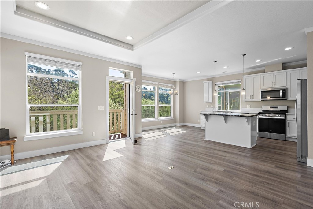 1460 Main Street, Unit 112 Cambria, CA 93428 - Photo 1 of 19 a view of kitchen with granite countertop a stove top oven a sink and a large window