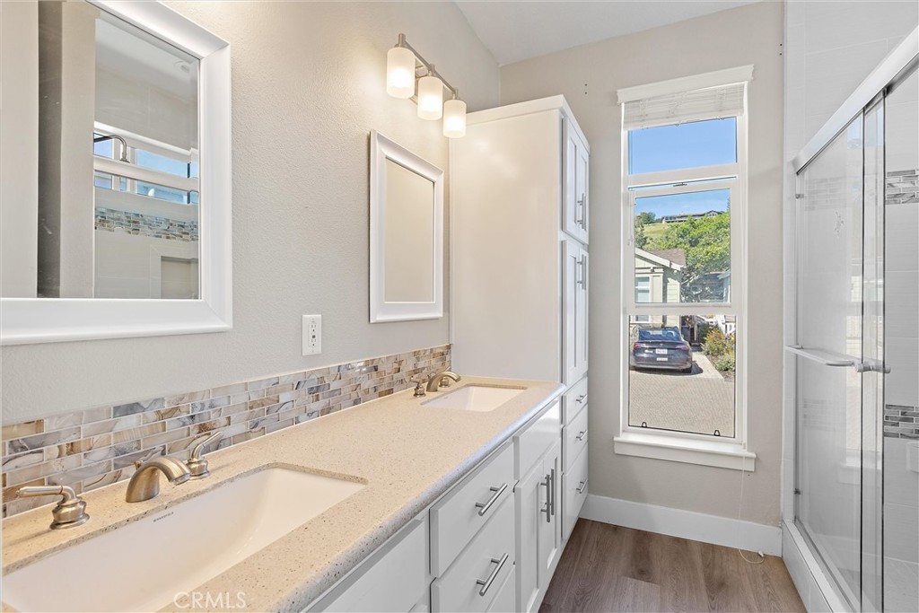1460 Main Street, Unit 112 Cambria, CA 93428 - Photo 11 of 19 a bathroom with a granite countertop sink mirror and double