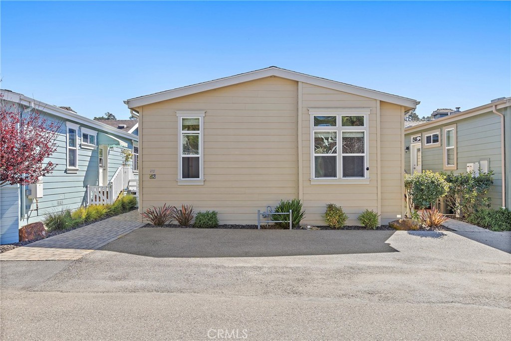 1460 Main Street, Unit 112 Cambria, CA 93428 - Photo 12 of 19 a front view of a house with a yard