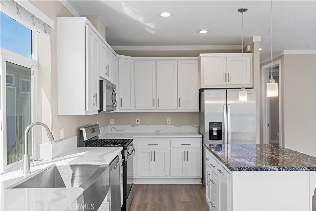 1460 Main Street, Unit 112 Cambria, CA 93428 - Photo 16 of 19 a kitchen with stainless steel appliances granite countertop a sink a refrigerator and a stove top oven