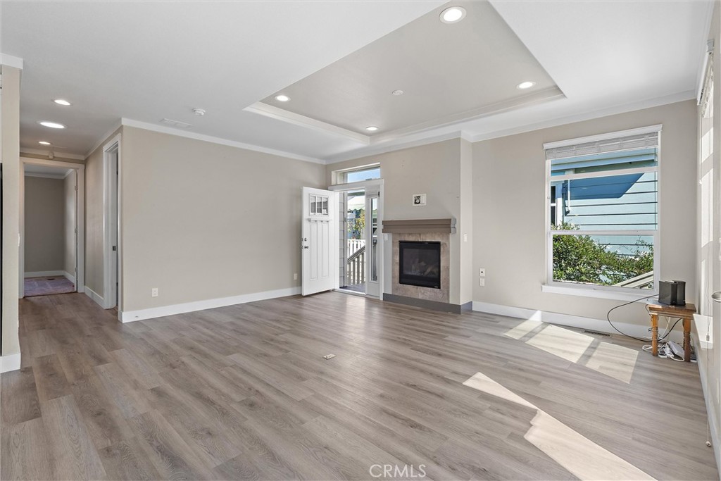 1460 Main Street, Unit 112 Cambria, CA 93428 - Photo 18 of 19 a view of empty room with wooden floor and fireplace