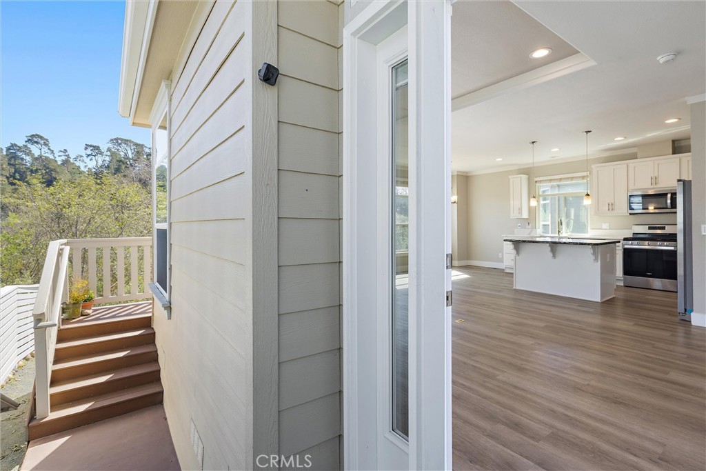 1460 Main Street, Unit 112 Cambria, CA 93428 - Photo 5 of 19 a view of kitchen and wooden floor