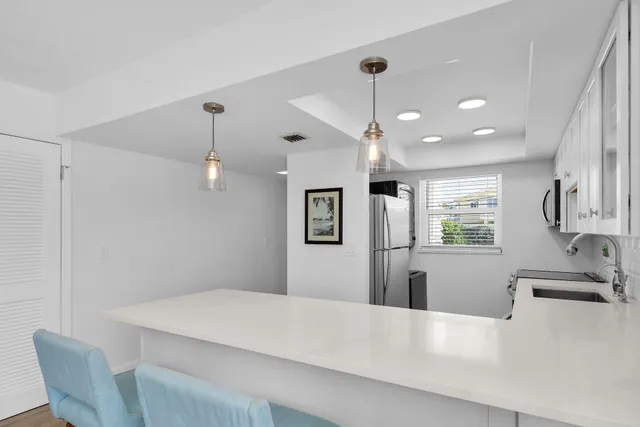 a view of a dining room with furniture and chandelier