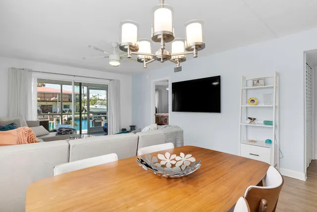 a living room with furniture and a large window with balcony view