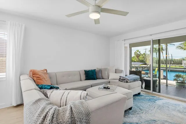 a living room with furniture and a chandelier
