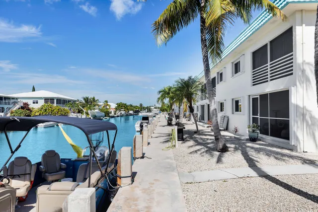 a view of swimming pool with outdoor seating and lake view