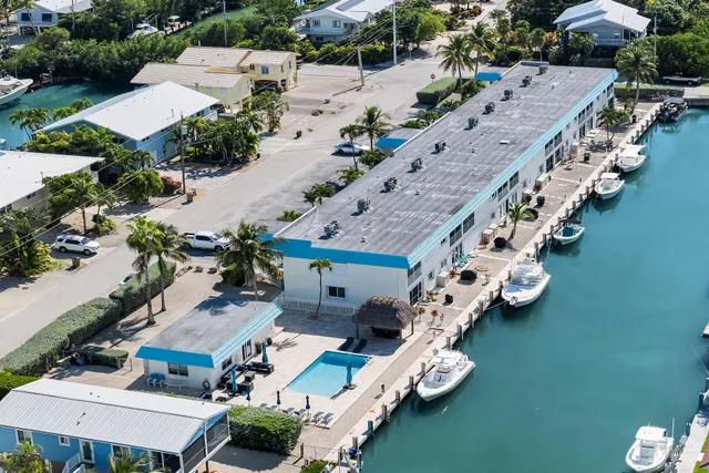 an aerial view of a house with outdoor space pool seating area and car parked