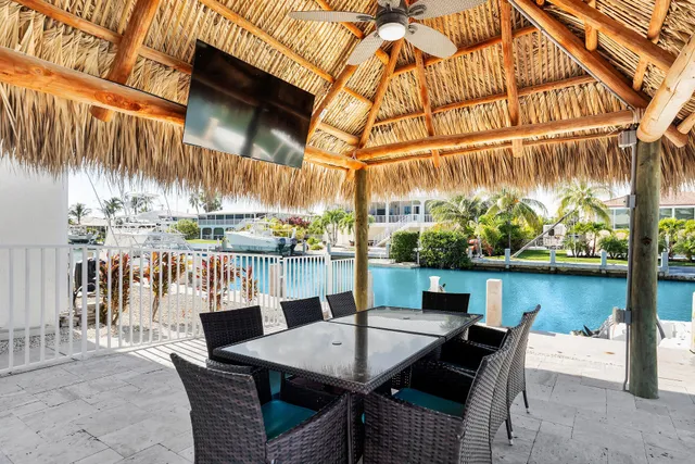 a view of a house with swimming pool and sitting area