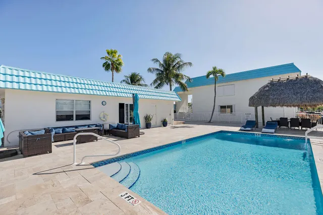a swimming pool view with a outdoor seating