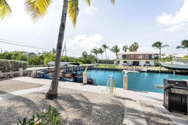 a lake view with a table and chairs