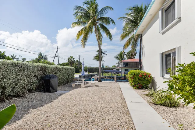 a view of a backyard with sitting area
