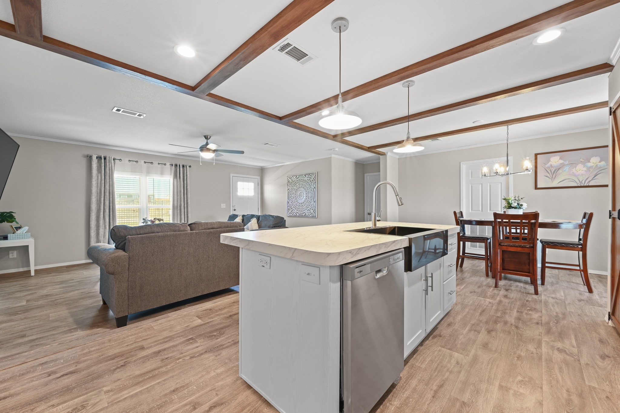 117 Castellana Way Elgin, TX 78621 - Photo 28 of 28 Kitchen featuring open floor plan, light countertops, white cabinetry, a center island with sink, and stainless steel dishwasher
