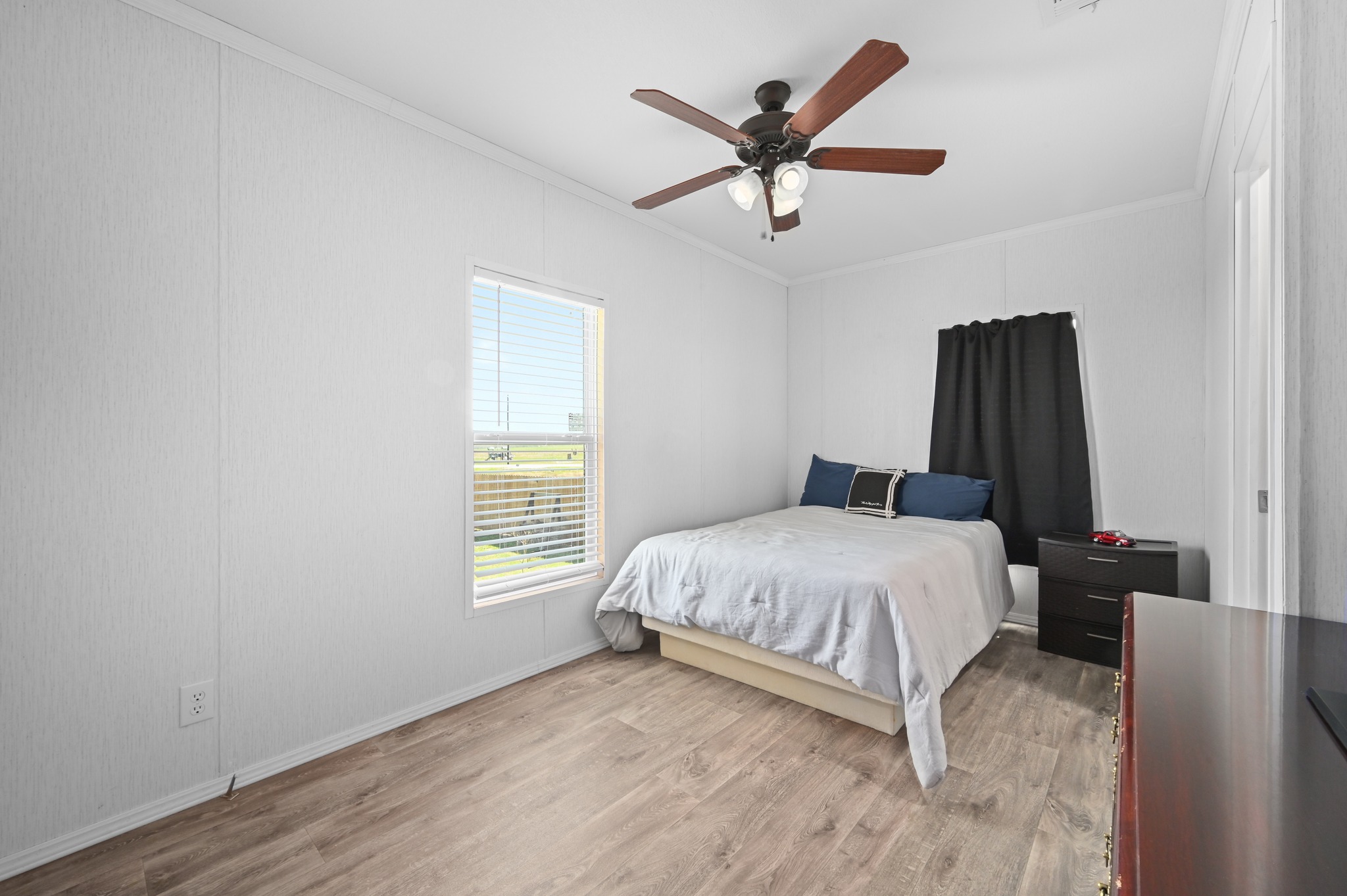 117 Castellana Way Elgin, TX 78621 - Photo 18 of 28 Bedroom featuring light wood-style flooring, ornamental molding, and ceiling fan