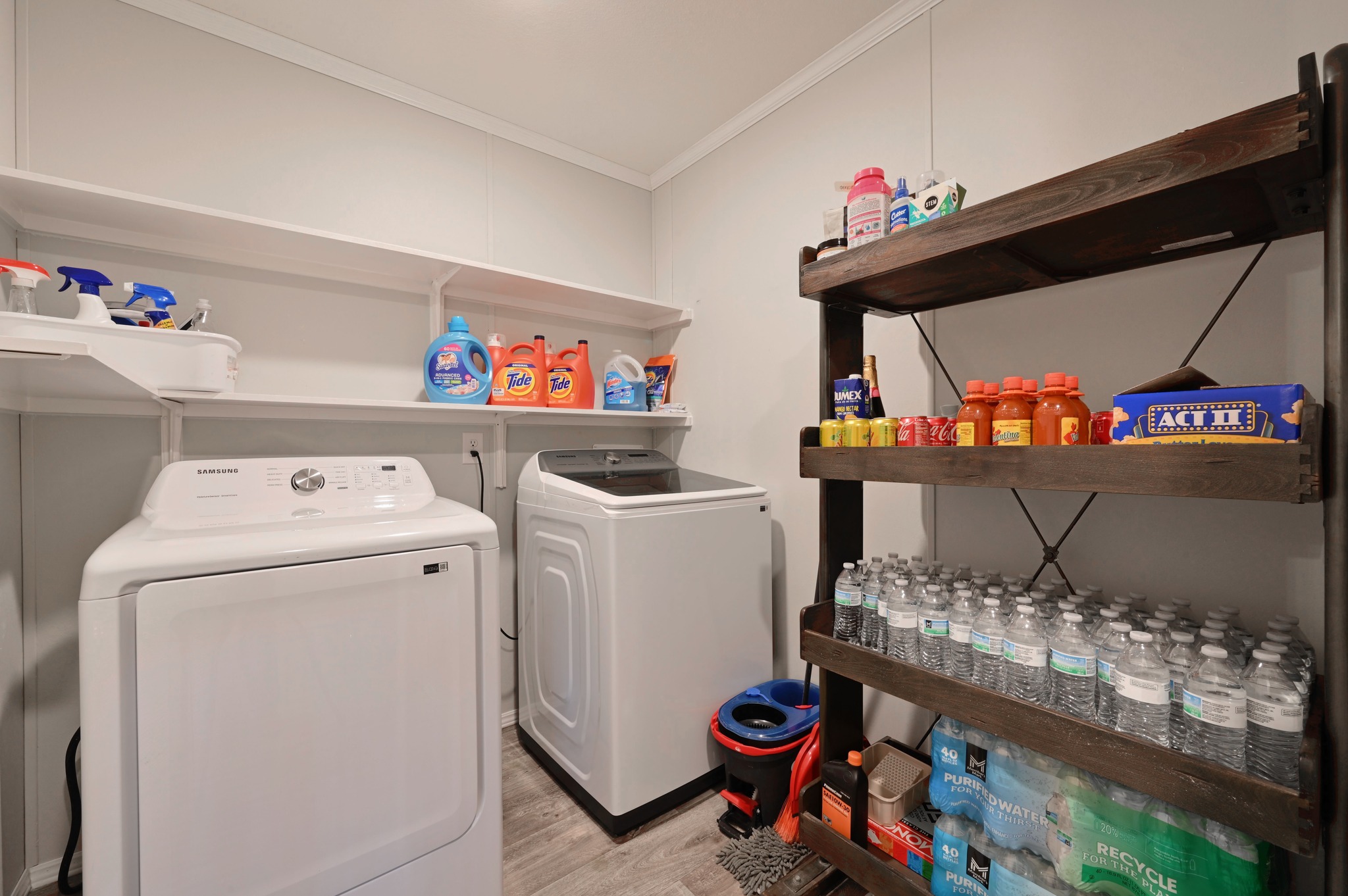 117 Castellana Way Elgin, TX 78621 - Photo 20 of 28 Laundry room featuring crown molding, light wood-type flooring, and independent washer and dryer