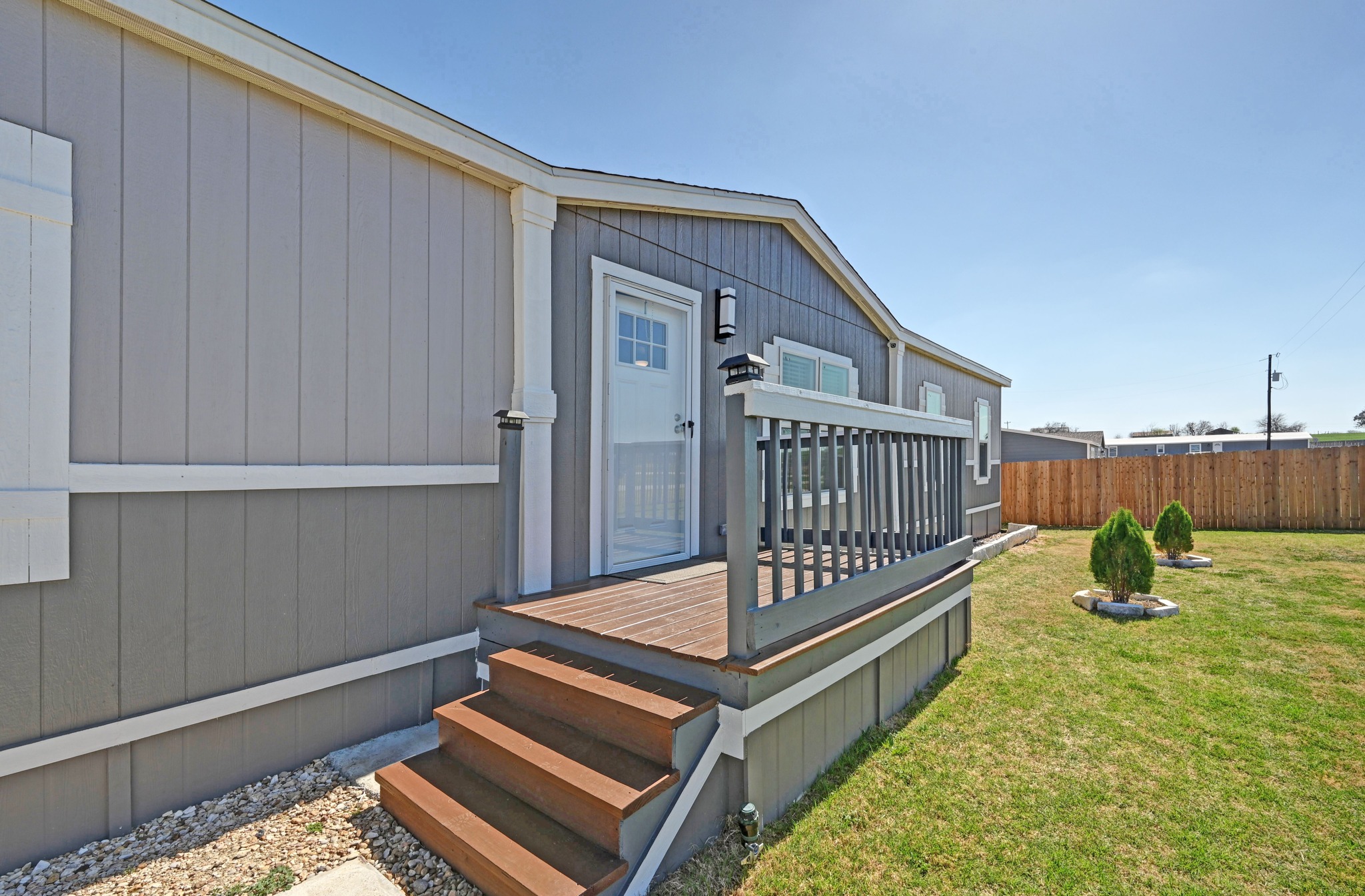 117 Castellana Way Elgin, TX 78621 - Photo 4 of 28 View of exterior entry featuring a wooden deck