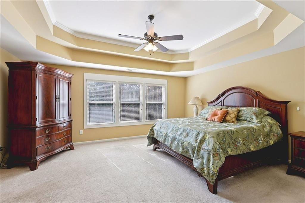 4460 Granby Circle Cumming, GA 30041 - Photo 15 of 34 a spacious bedroom with a bed and a dresser