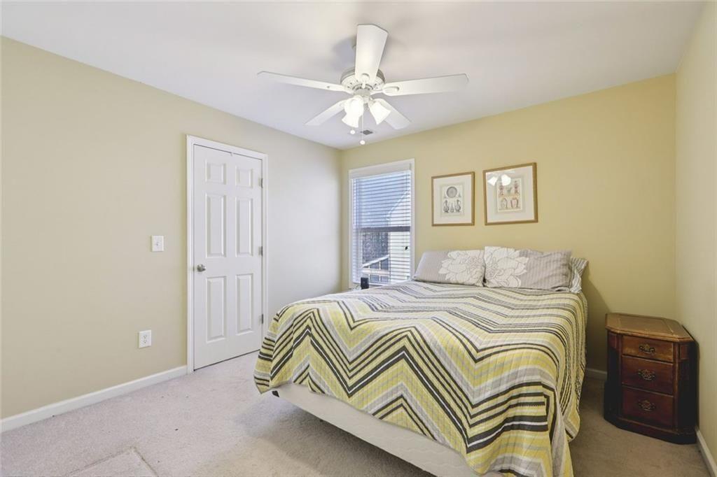 4460 Granby Circle Cumming, GA 30041 - Photo 18 of 34 a bedroom with a bed and a chandelier