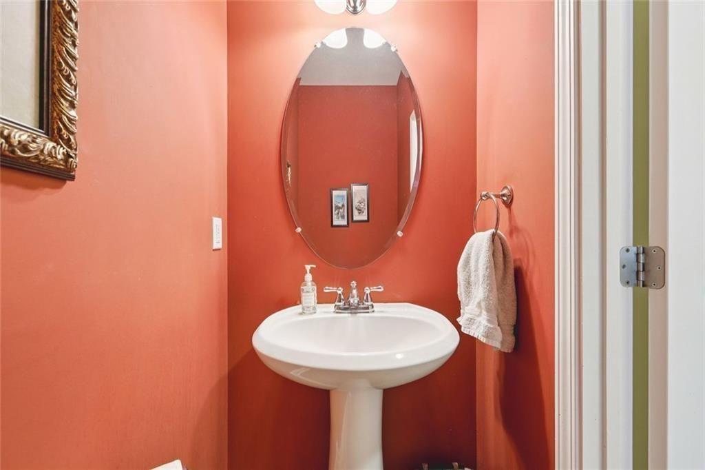 4460 Granby Circle Cumming, GA 30041 - Photo 23 of 34 a bathroom with a sink and a mirror