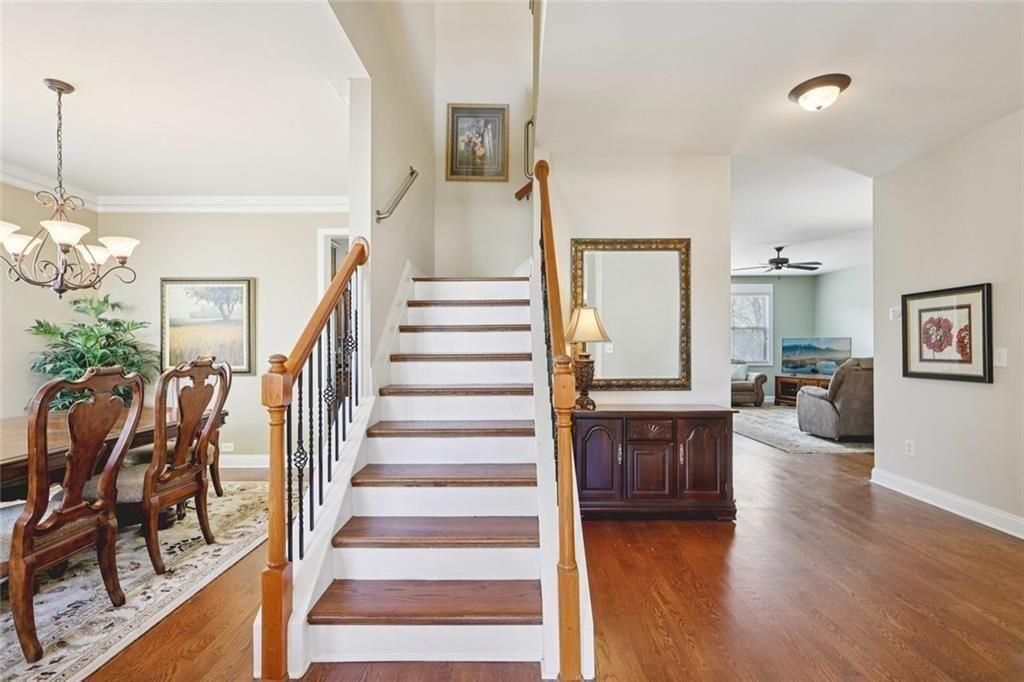 4460 Granby Circle Cumming, GA 30041 - Photo 4 of 34 a view of a livingroom with furniture stairs wooden floor and windows