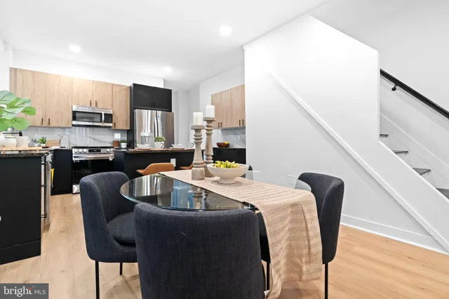 a kitchen with granite countertop a sink stainless steel appliances and cabinets