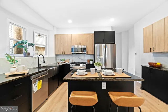 a kitchen with a refrigerator a stove a sink and a stove