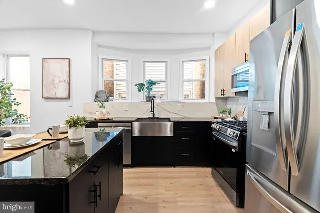 a kitchen with granite countertop a stove and a sink