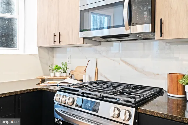 a view of a dining room with a table and chairs