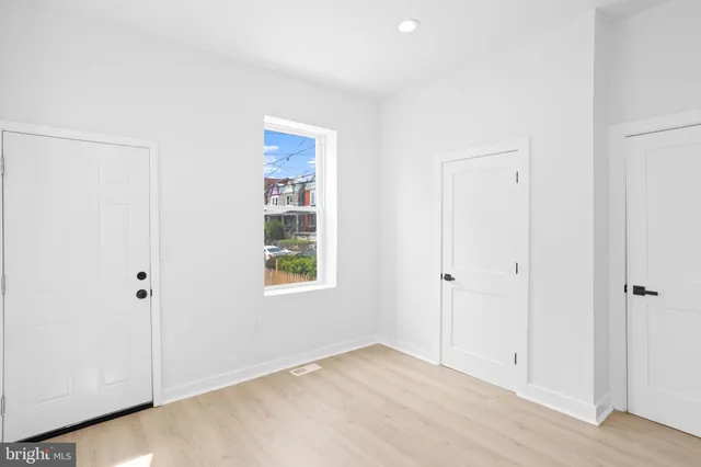 a view of a house with a wooden fence