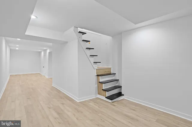 a view of a big room with wooden floor and doors