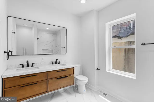 a bedroom with a large bed and a painting on the wall