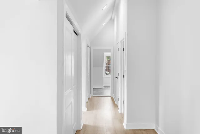 a view of a hallway with wooden floor