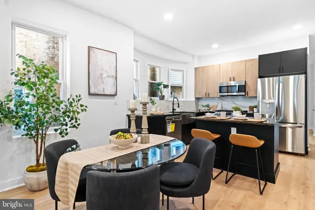 a living room with furniture potted plant and a window