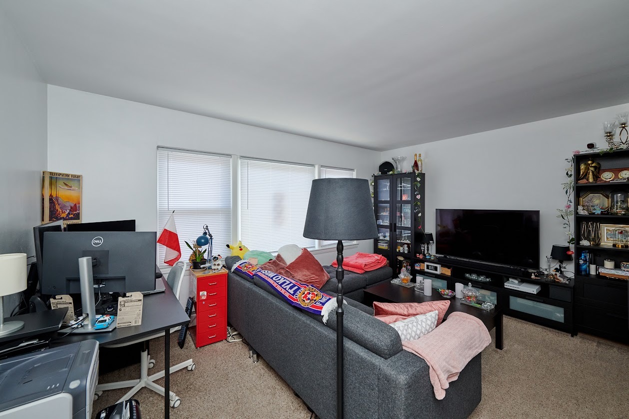 8211 West Irving Park Road Chicago, IL 60634 - Photo 12 of 28 a living room with furniture and a flat screen tv
