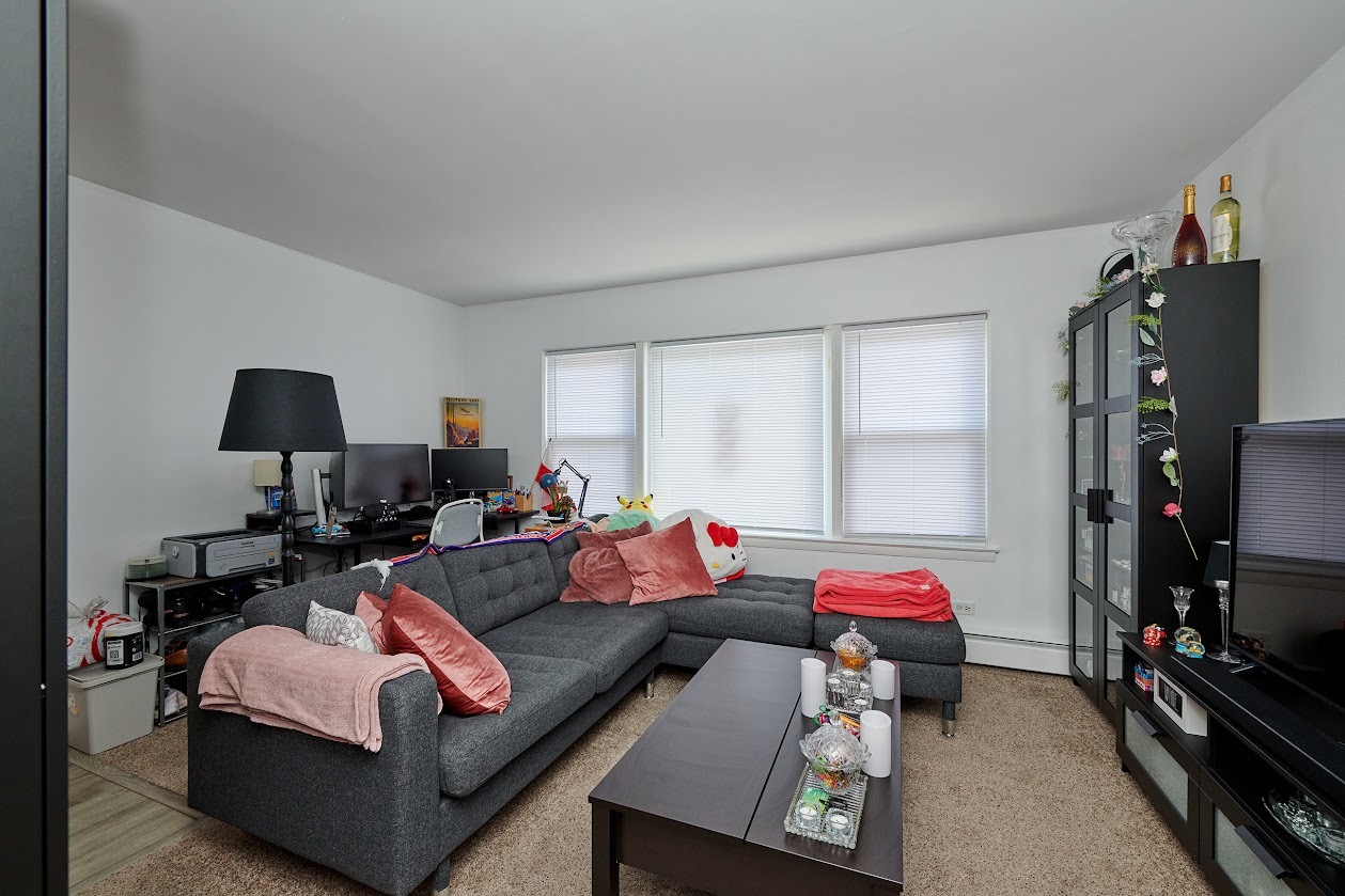 8211 West Irving Park Road Chicago, IL 60634 - Photo 13 of 28 a living room with furniture and a flat screen tv