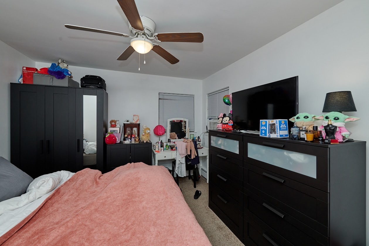 8211 West Irving Park Road Chicago, IL 60634 - Photo 14 of 28 a bedroom with a bed and a flat tv screen on dresser