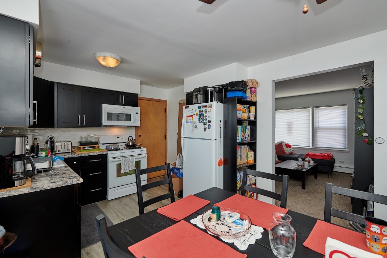 8211 West Irving Park Road Chicago, IL 60634 - Photo 16 of 28 a living room with stainless steel appliances furniture and a flat screen tv