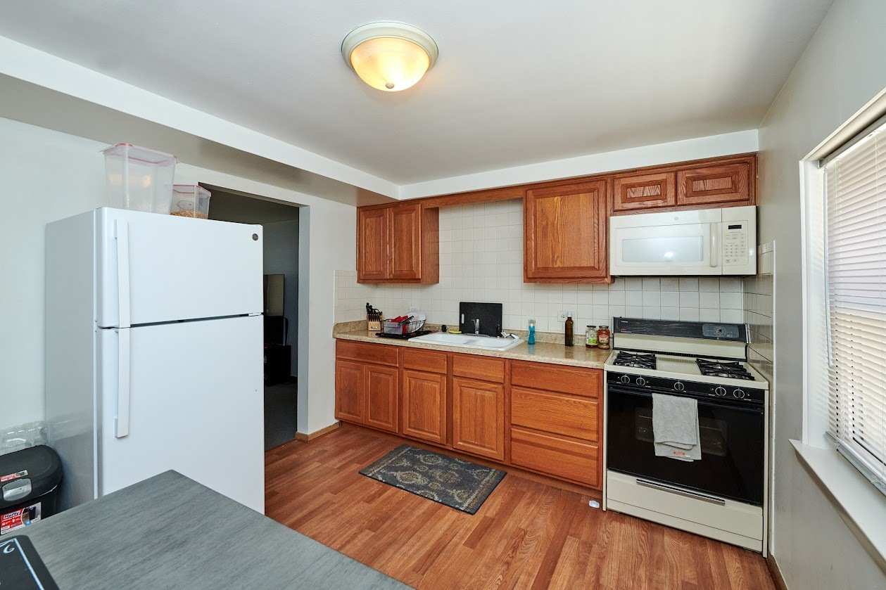 8211 West Irving Park Road Chicago, IL 60634 - Photo 20 of 28 a kitchen with stainless steel appliances granite countertop a refrigerator sink and stove