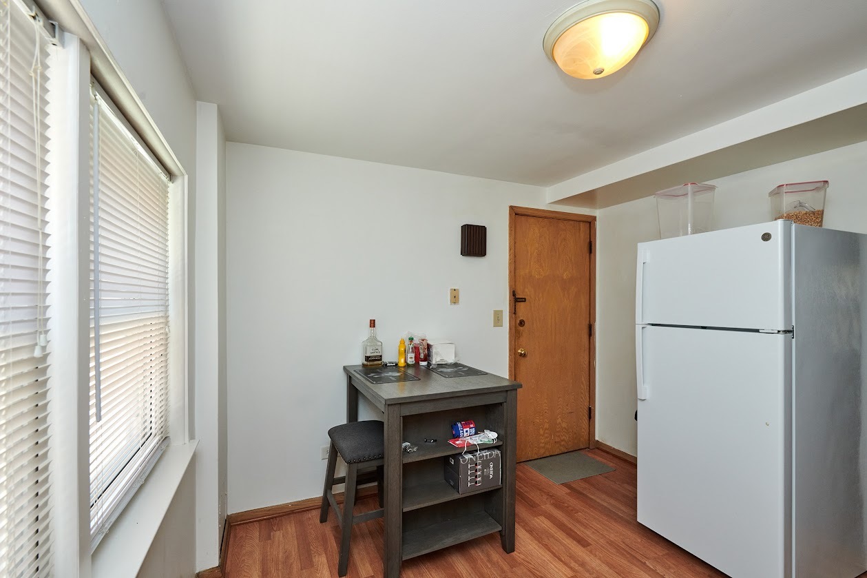 8211 West Irving Park Road Chicago, IL 60634 - Photo 21 of 28 a view of a kitchen with fridge and wooden floor