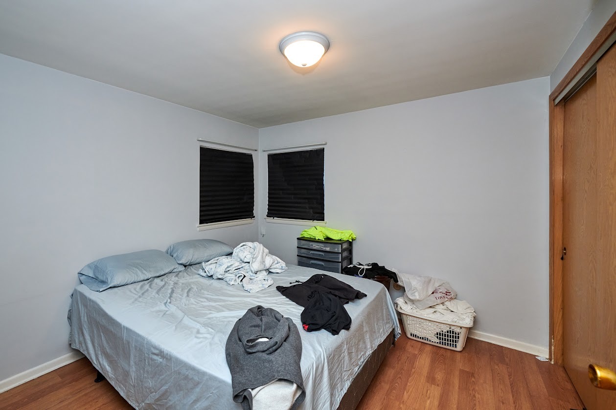 8211 West Irving Park Road Chicago, IL 60634 - Photo 22 of 28 a bedroom with a bed and wooden floor