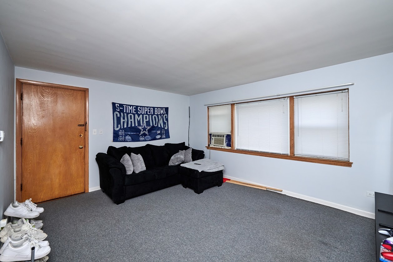 8211 West Irving Park Road Chicago, IL 60634 - Photo 25 of 28 a living room with furniture and a window