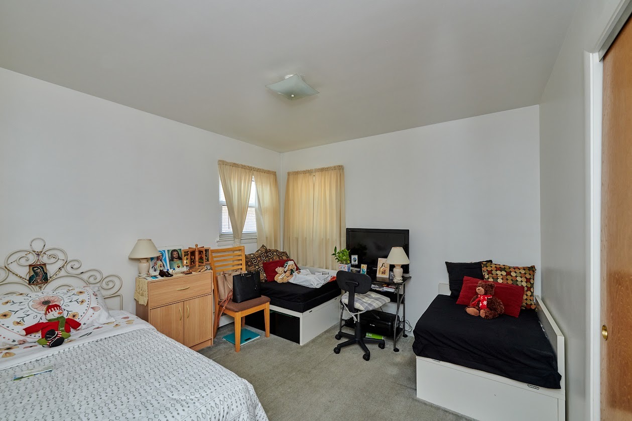 8211 West Irving Park Road Chicago, IL 60634 - Photo 6 of 28 a bedroom with furniture and a bed