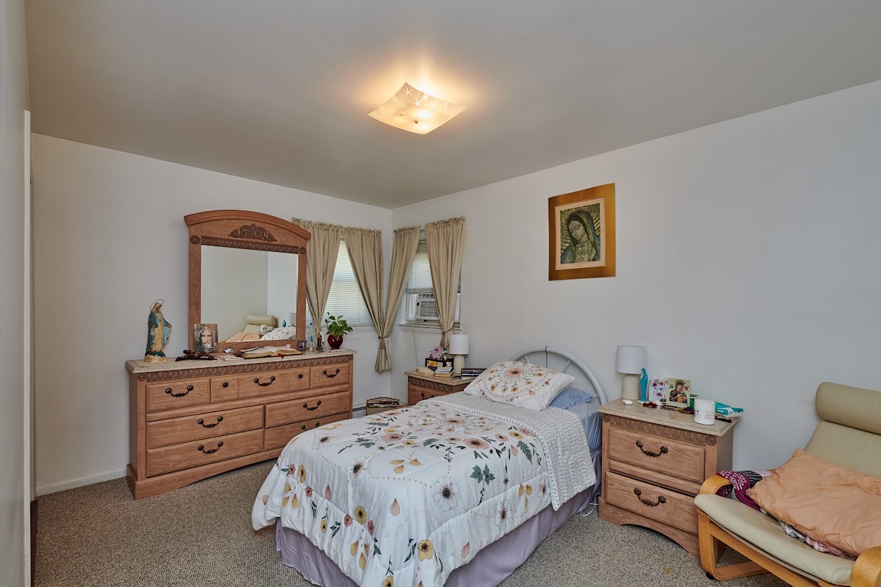 8211 West Irving Park Road Chicago, IL 60634 - Photo 7 of 28 a bedroom with a bed and a dresser