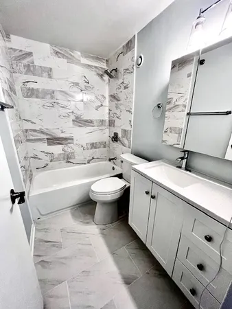 a bathroom with a double vanity sink toilet and shower