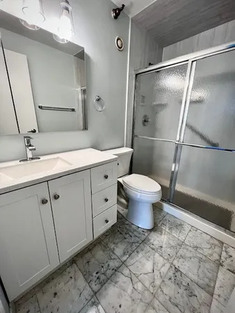 a bathroom with a sink toilet and a shower