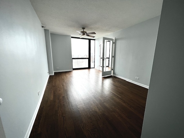 1122 North Clark Street, Unit 2806 Chicago, IL 60610 - Photo 17 of 20 an empty room with wooden floor chandelier and windows