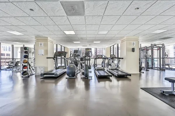 a view of a room with lots of gym equipment